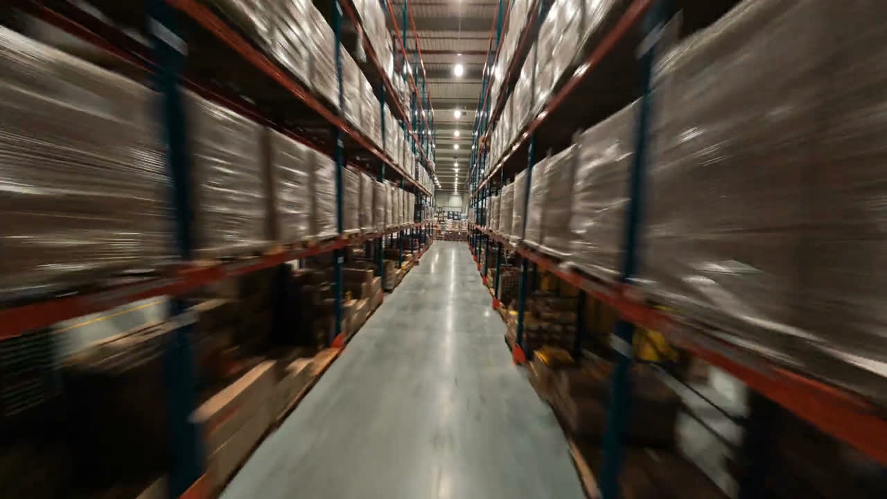 Moving through a long warehouse aisle